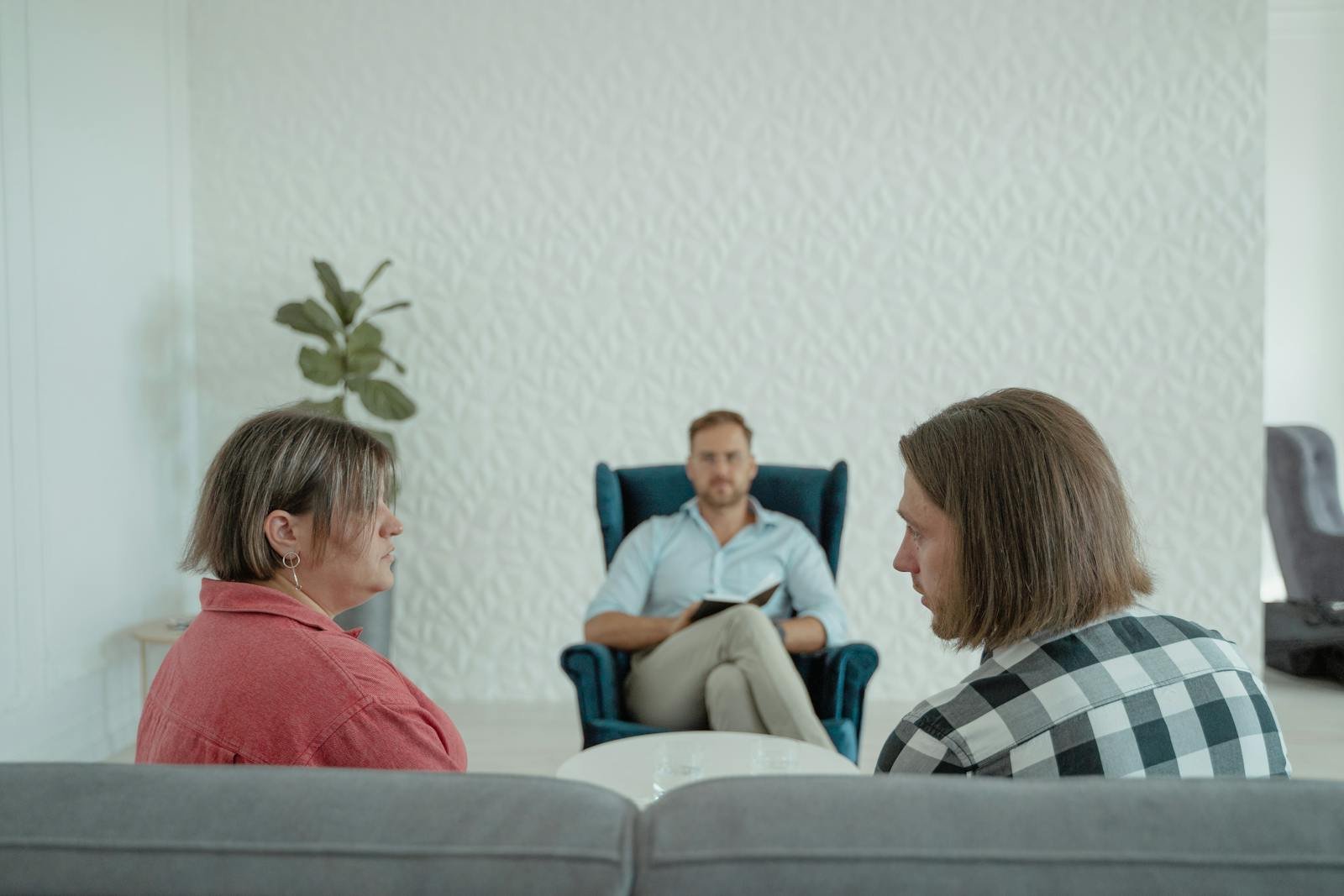 A Counselor Listening to a Married Couple Marital Problems couple counseling session in Joliet