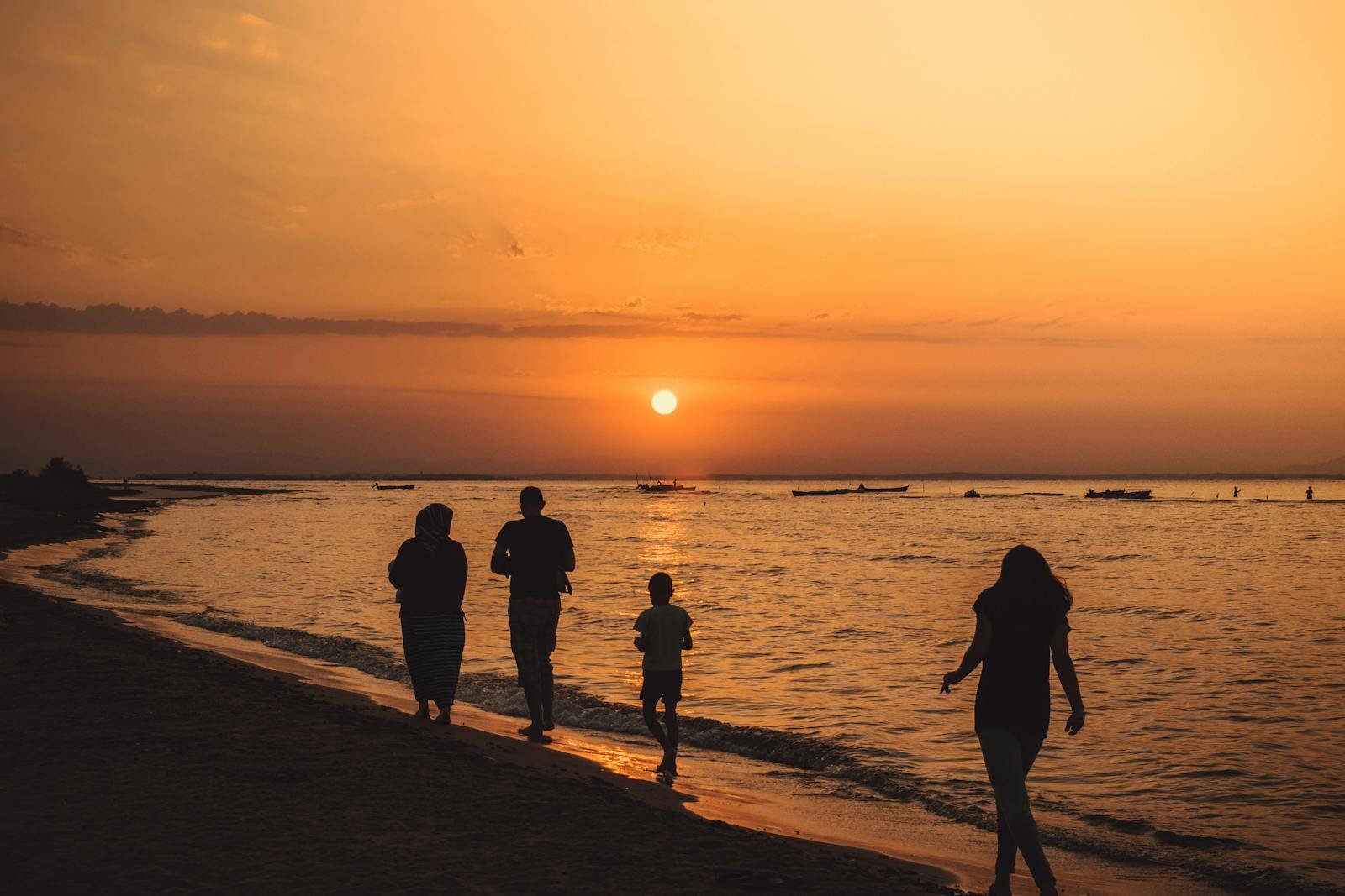 A Family Walking On Seashore During Sunset after taking family therapy