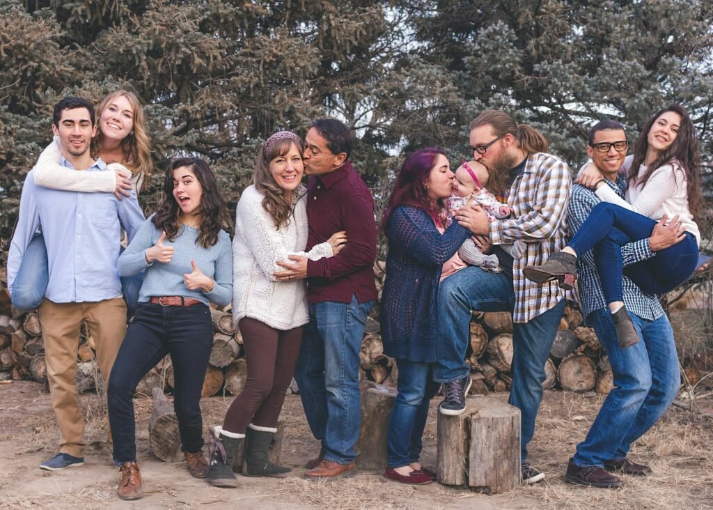 People Standing in Front of Wood Pile feeling happy after family counseling