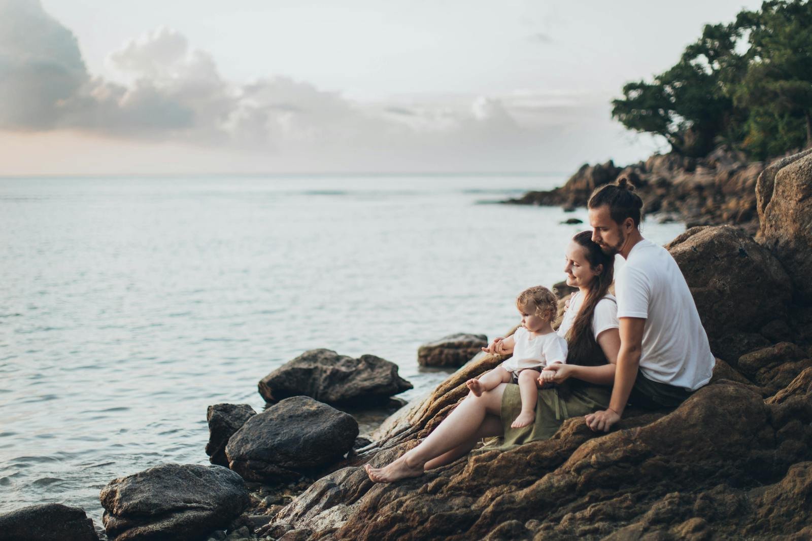 Man and Woman Sitting on Rock Near Seashore after taking family therapy in joliet