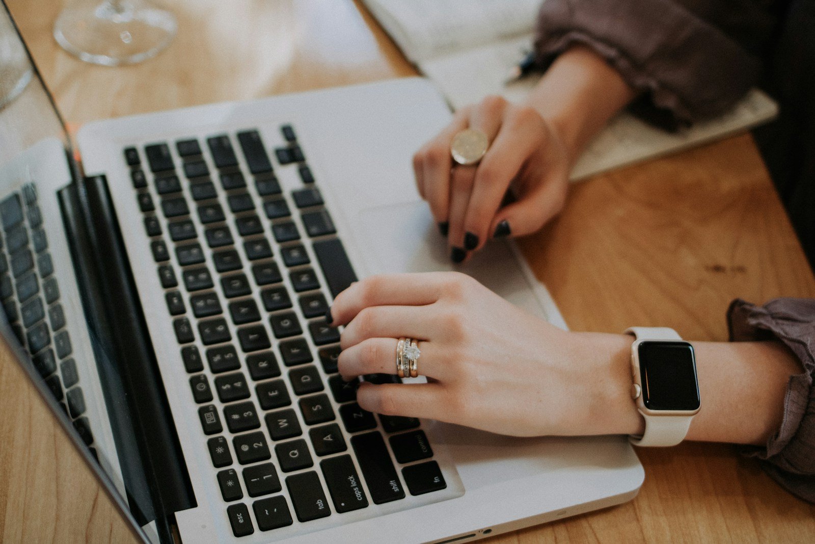 person using MacBook Reading The Benefits of Online Therapy for LGBTQ Individuals