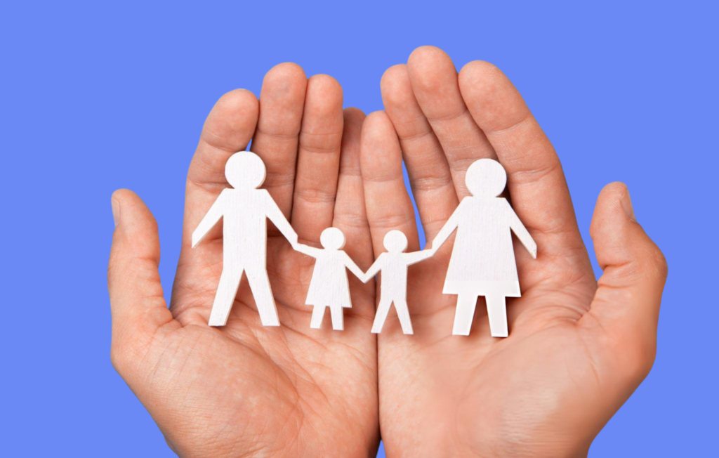 Two hands hold four paper cutouts of a family a man, a woman, and two children, set against a blue background. Showcasing Counseling in Chicago